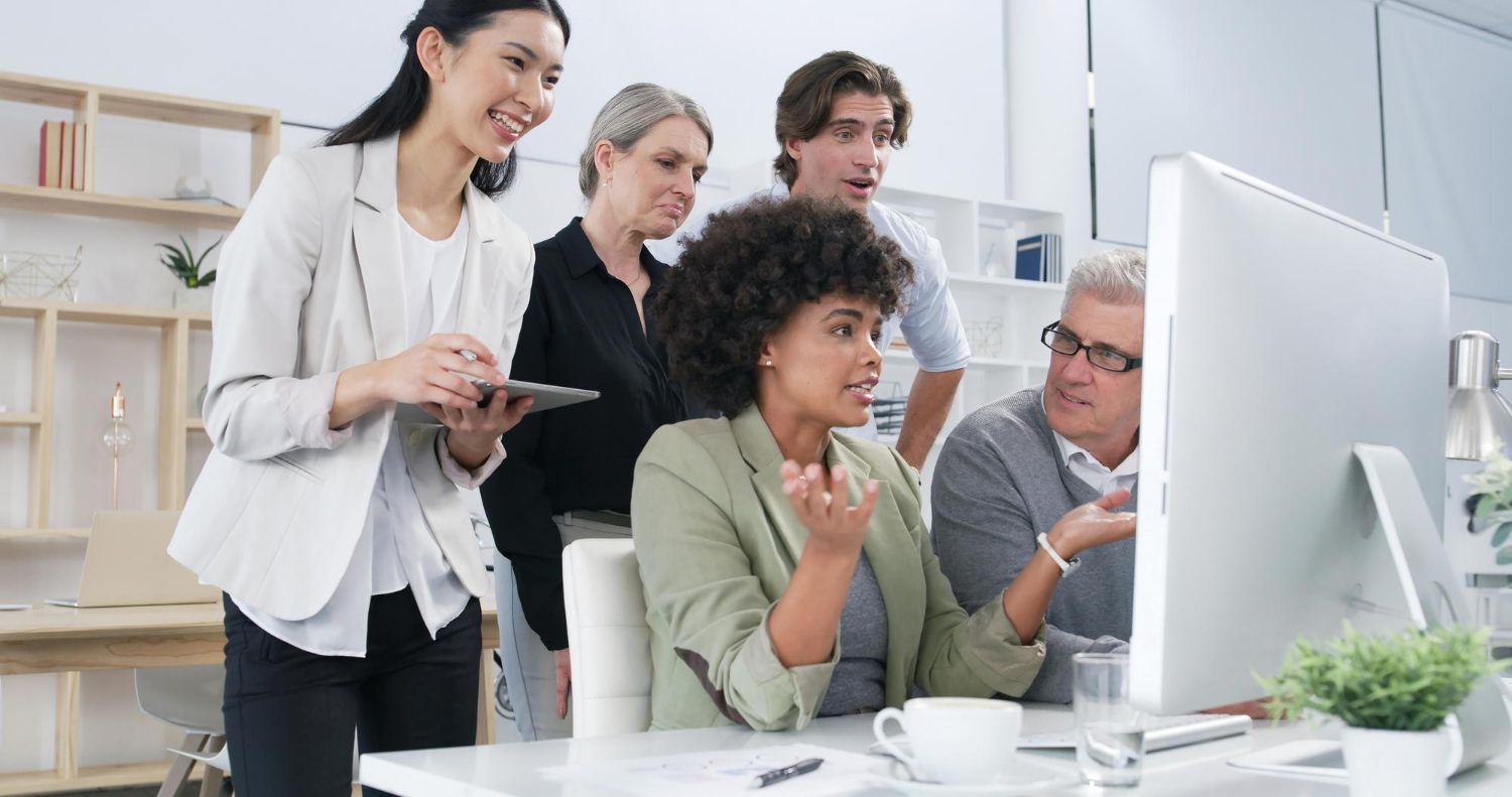 Experienced marketer coaching a team around one screen